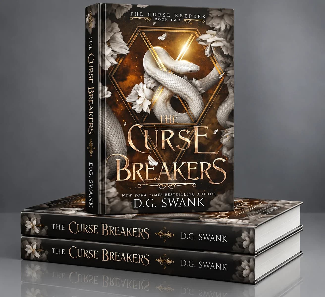 Hardcover mockup of The Curse Breakers, The Curse Keepers Book Two, by D.G. Swank: one book standing on two stacked copies, its cover showing a white snake coiled through a gold hexagonal frame with ivory flowers, and gold title lettering repeated on the spines.
